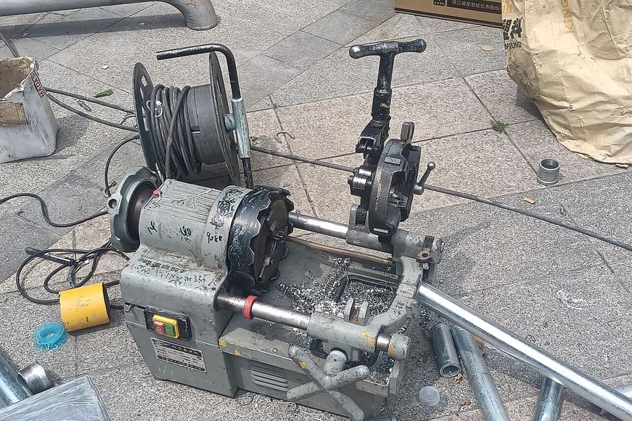 Portable grooving machine set up with pipes on site