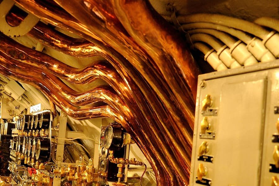 Polished copper and brass tubing installed in an engine room
